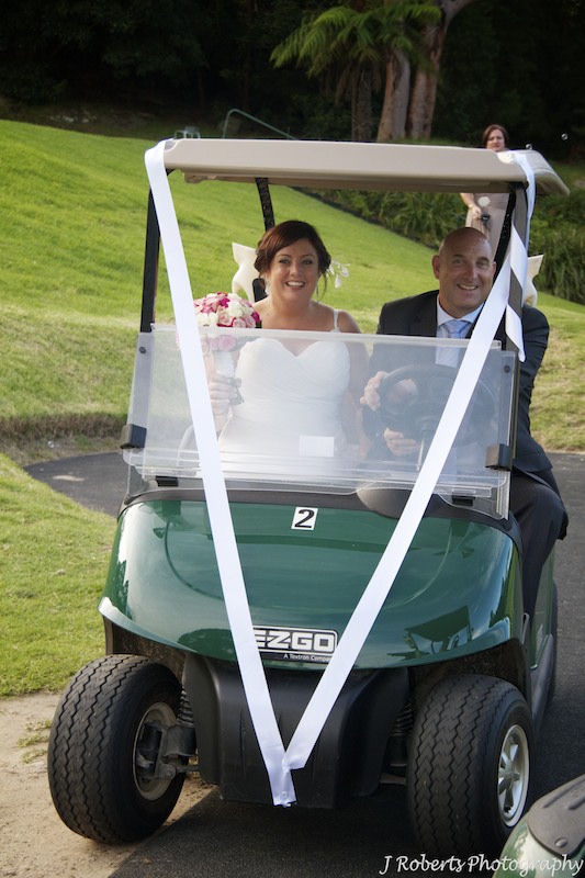 Bride and groom on golf cart - wedding photography sydney